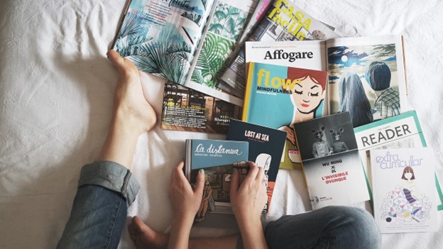 Woman skimming through books and magazines.