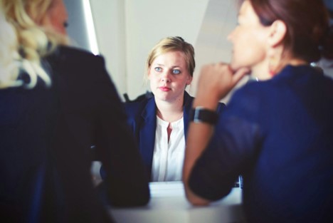 Professionals discussing the perks of a bachelor’s degree in human resources.