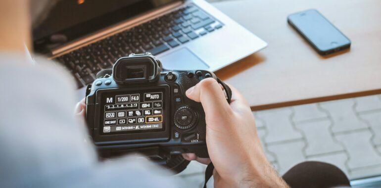 A student exploring camera options during an online photography degree course.