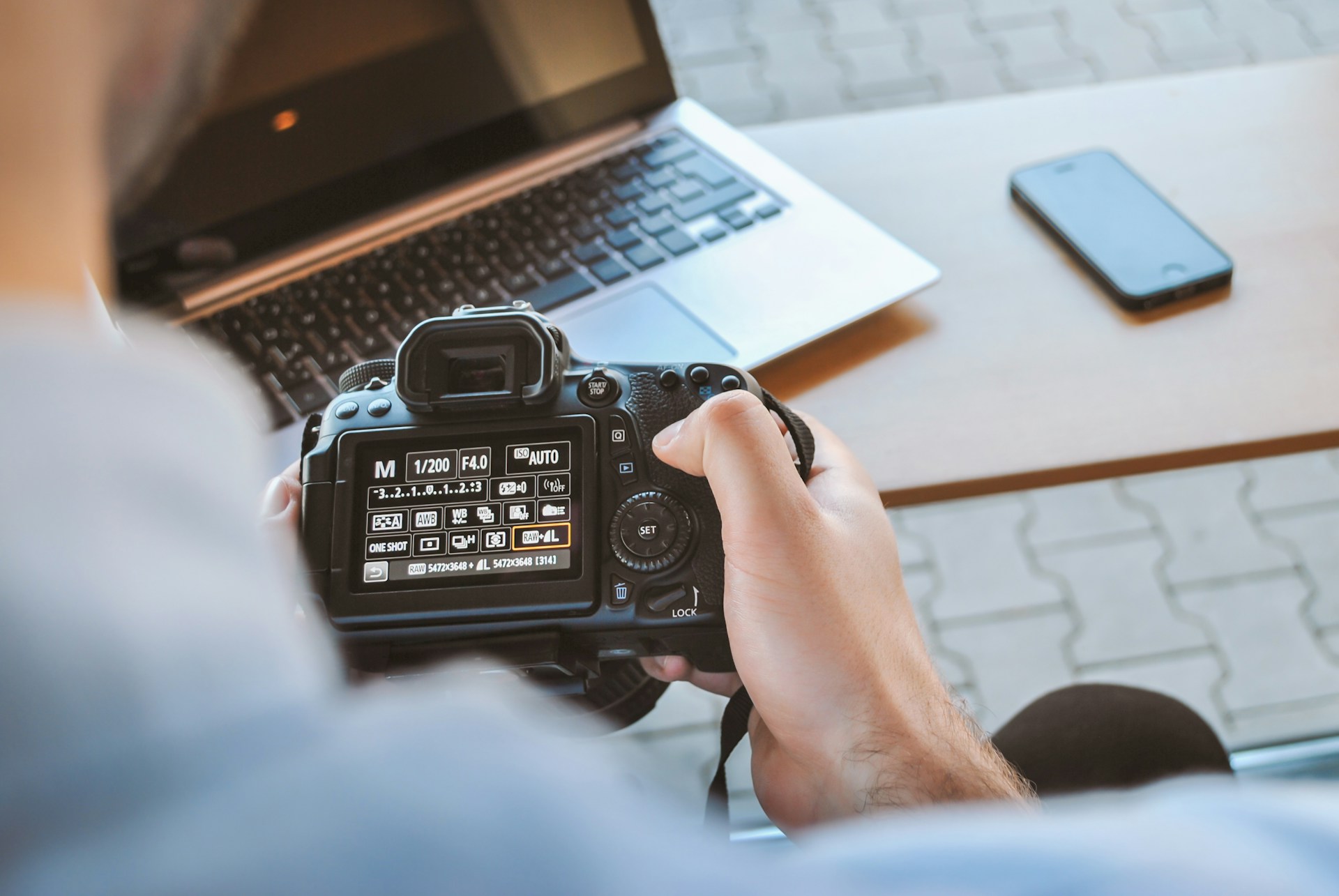 A student exploring camera options during an online photography degree course.