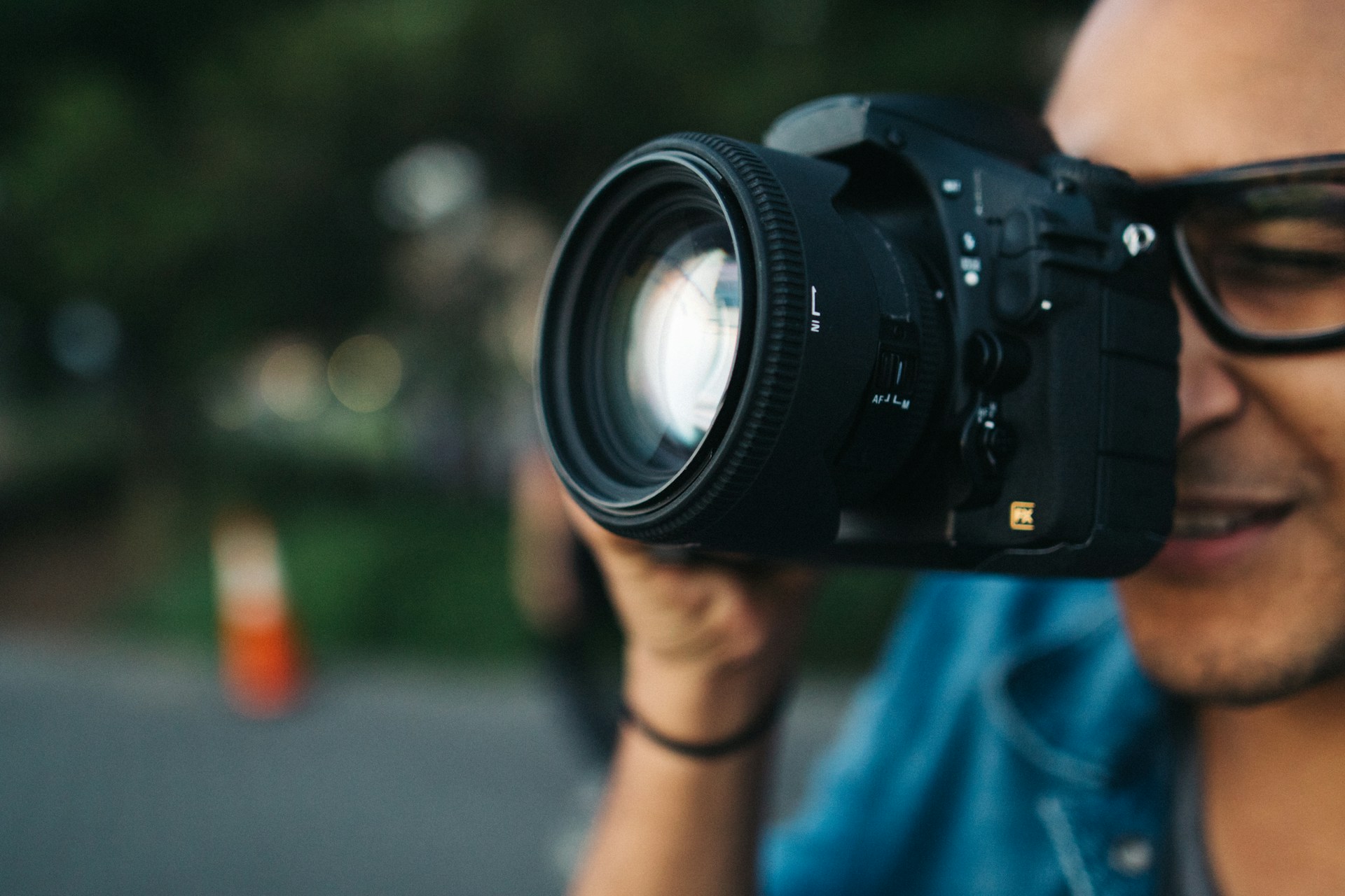 Photography student taking a photo for his portfolio to apply to photography programs online.