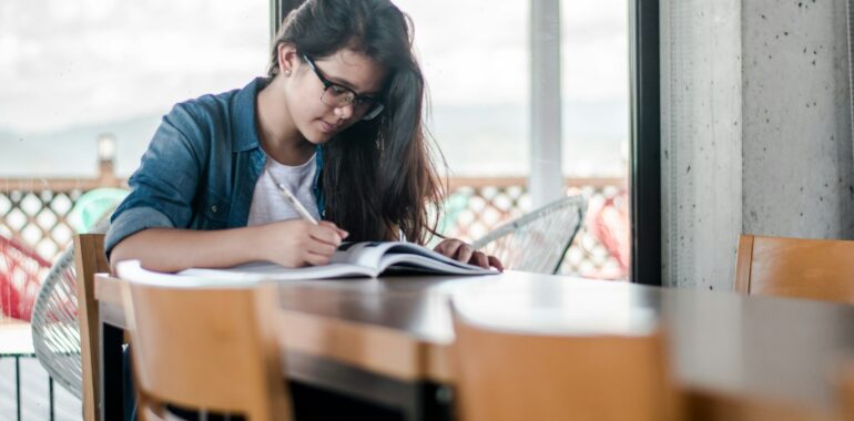 Student marking potential criminology jobs in a book.