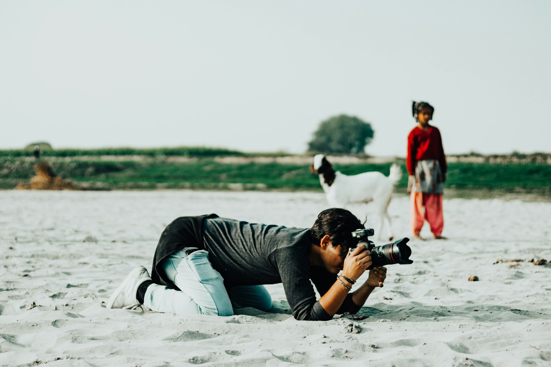 Student clicking a photo for his photography program online.