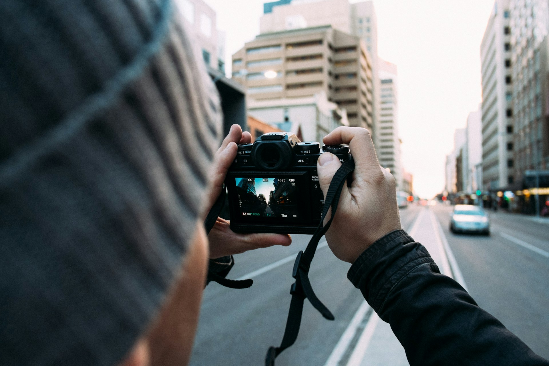 A person clicking a photo to impress professionals in photography colleges in Alabama. 