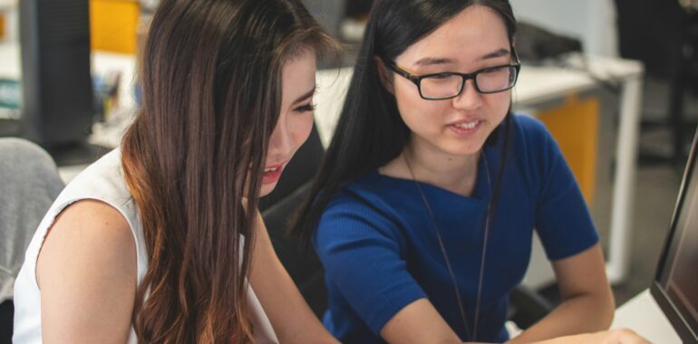 Students discussing good colleges in New York with a photography degree.