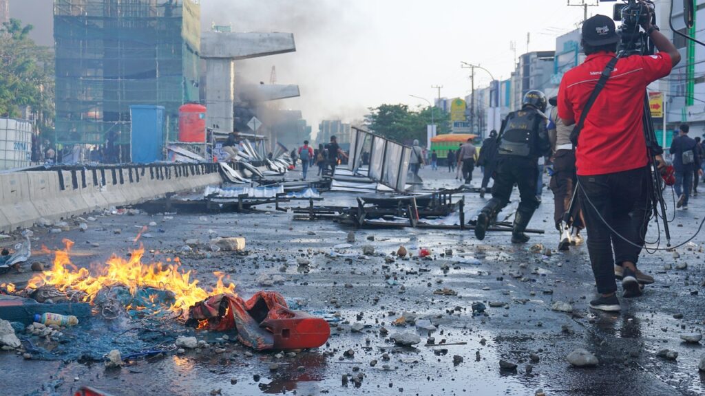 Photojournalist covering the aftermath of a fire